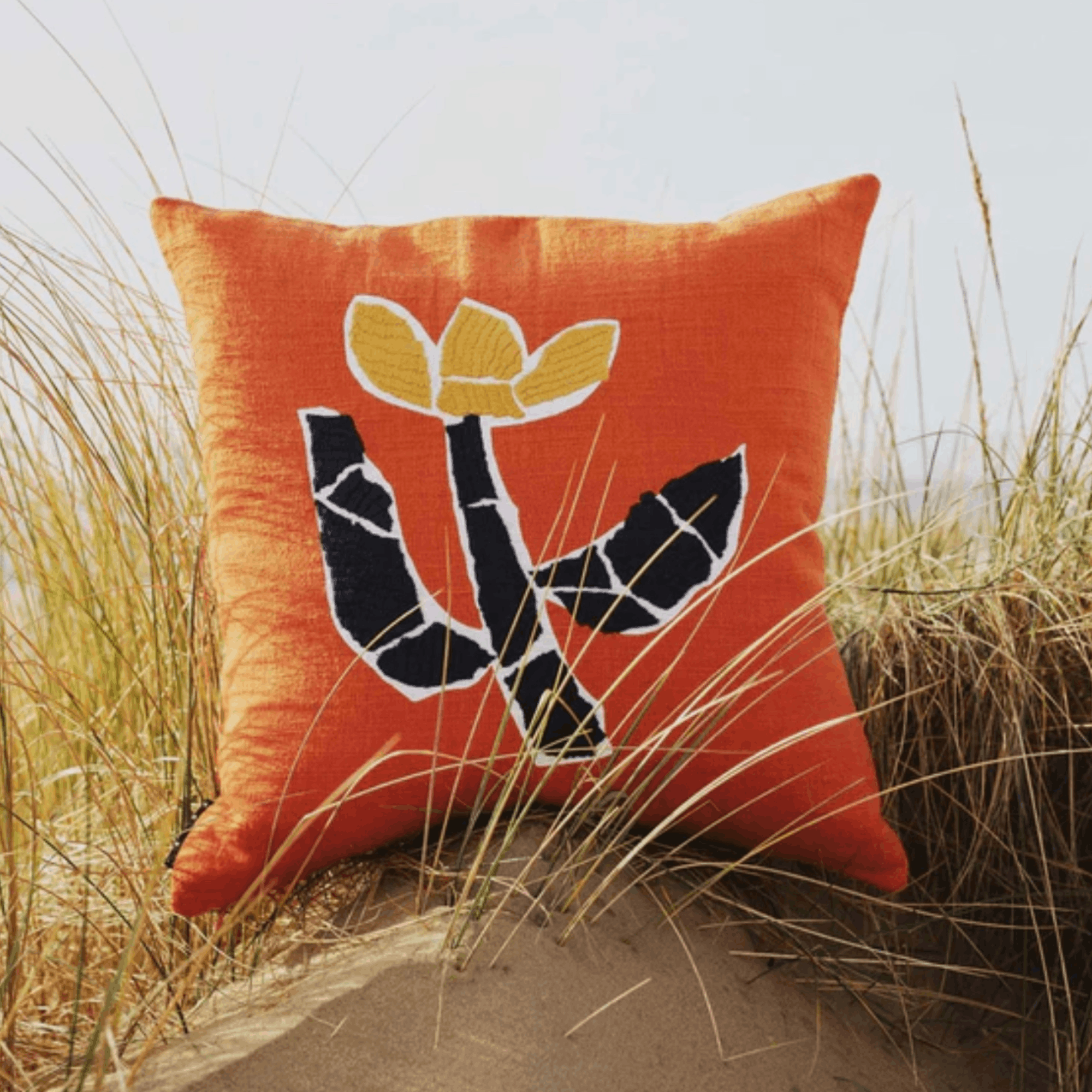 Contemporary cotton cushion cover with a screen-printed floral design by Charlie Sheppard, bringing colour and texture to modern interiors.