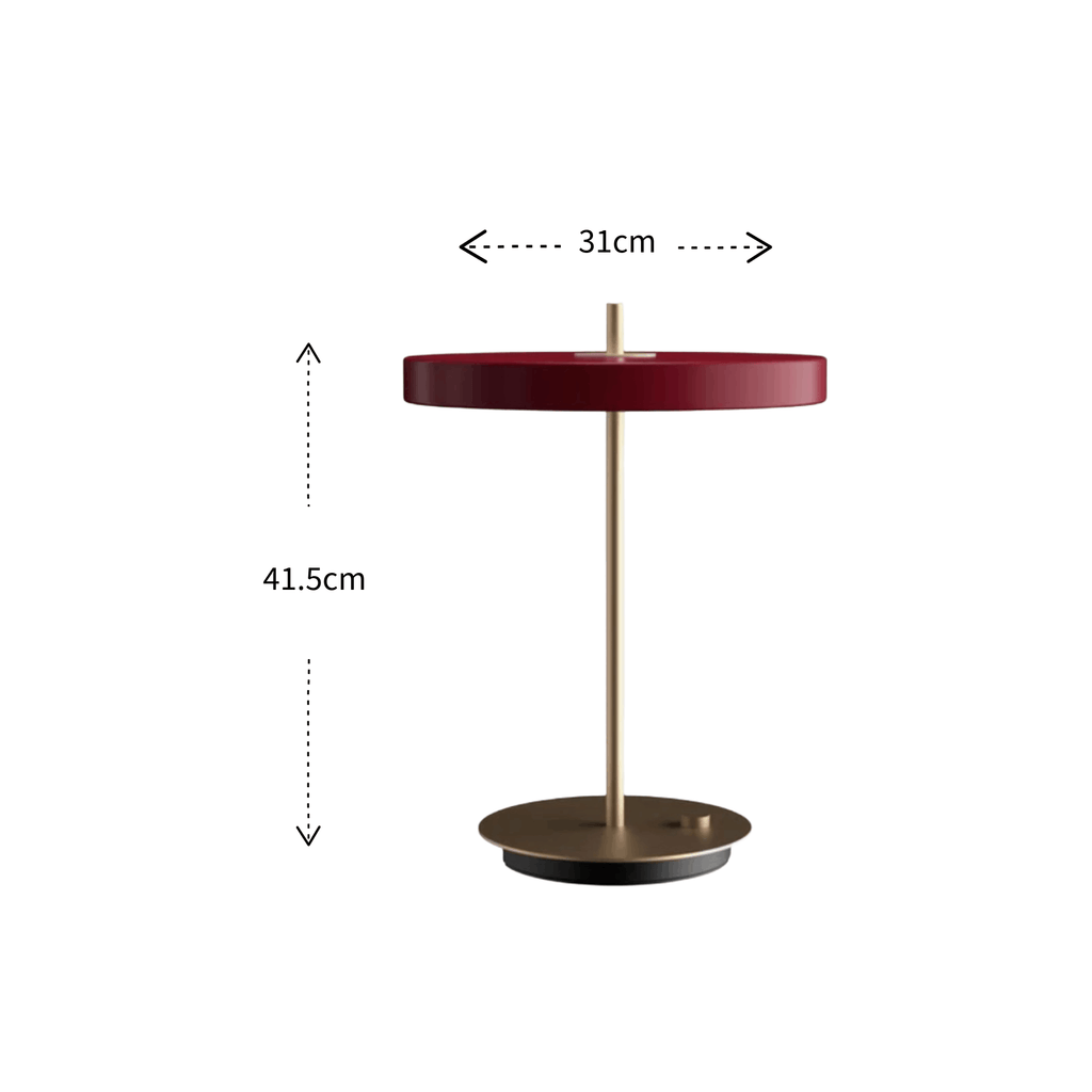 A modern table lamp with a round dark red top, a slim gold metal stem, and a circular gold base, shown on a white background with dimension labels indicating 31 cm width and 41.5 cm height.