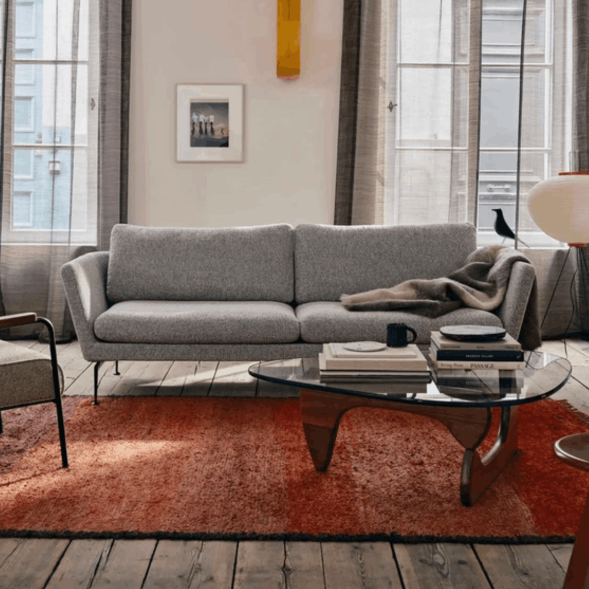 Vitra Coffee Table by Isamu Noguchi in walnut with sculptural interlocking wooden base and curved clear glass top.