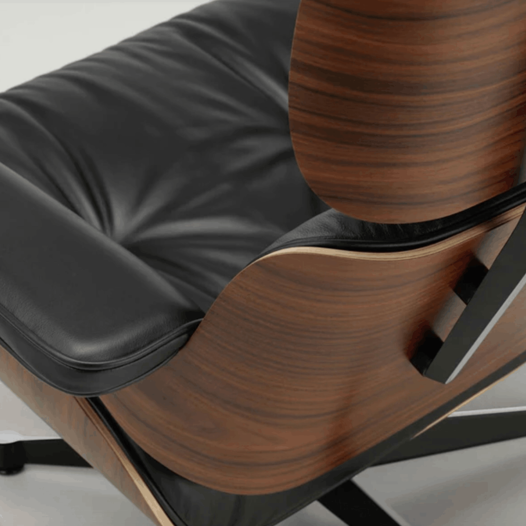 Close-up of a modern chair with wooden backrest and black cushioned seat.