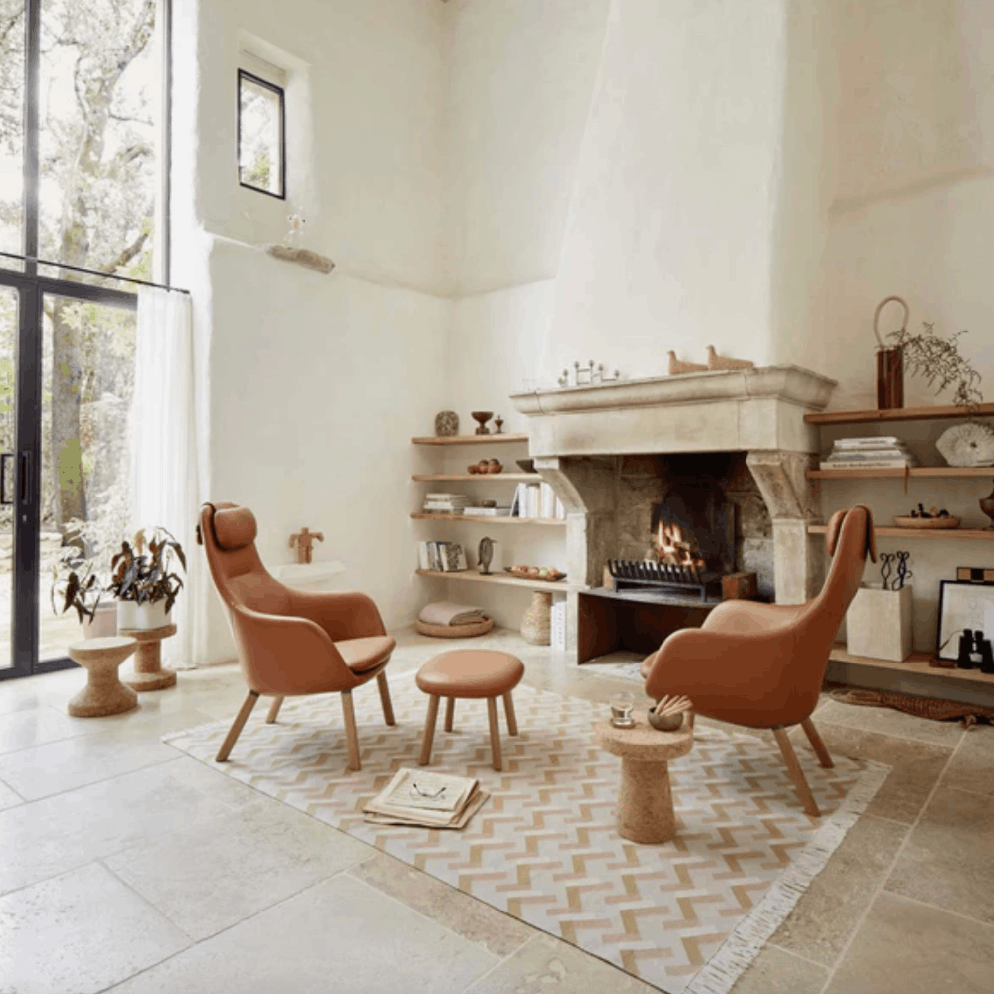 Modern living room with two brown chairs, a fireplace, and decorative items.